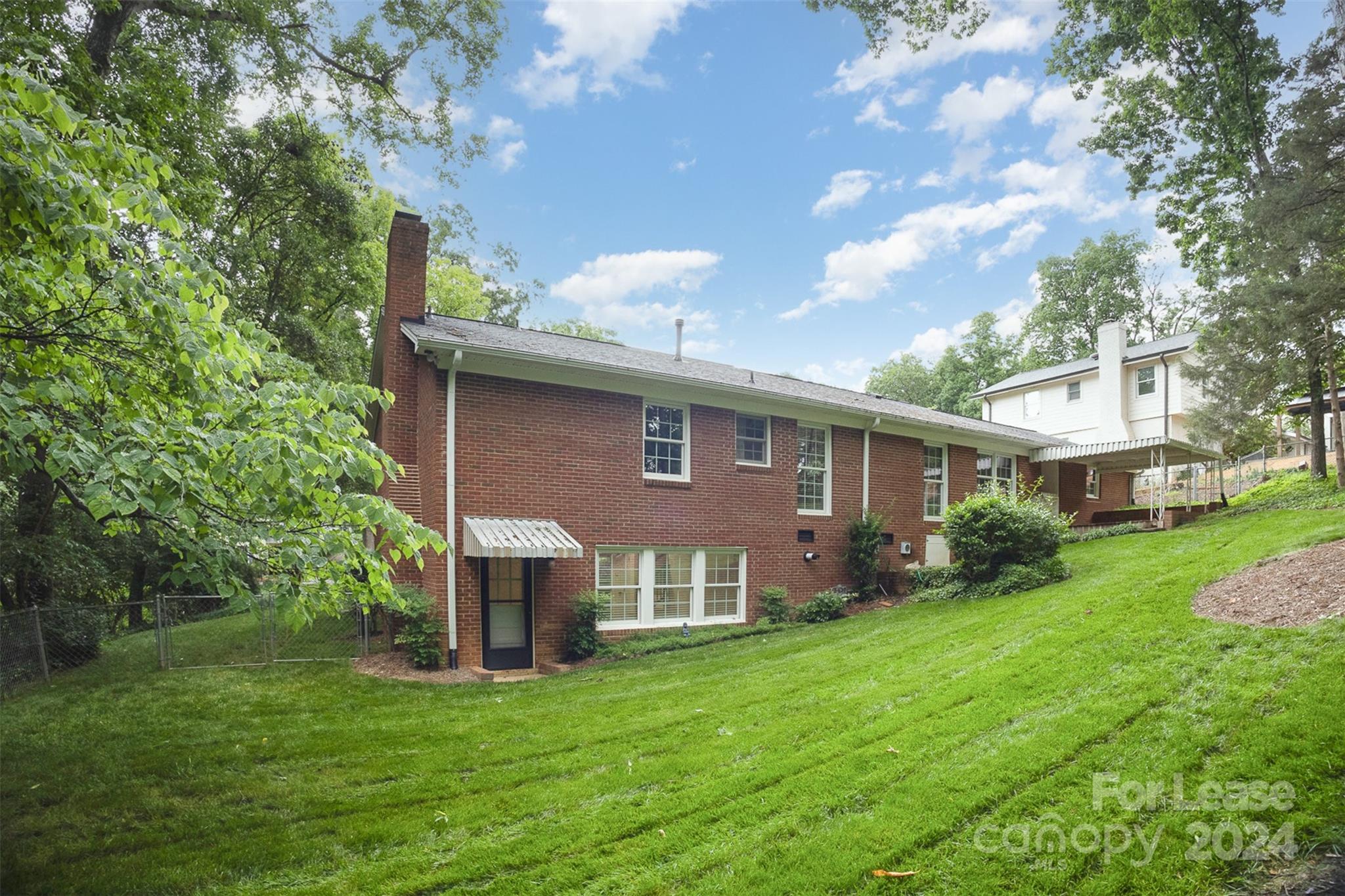 926 Shady Bluff Drive Charlotte, NC 28211 - Photo 41 of 44 a front view of a house with a garden and yard