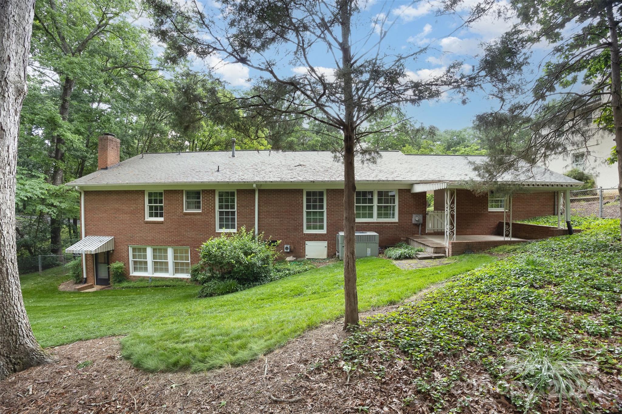 926 Shady Bluff Drive Charlotte, NC 28211 - Photo 42 of 44 a view of a house with a yard and sitting area