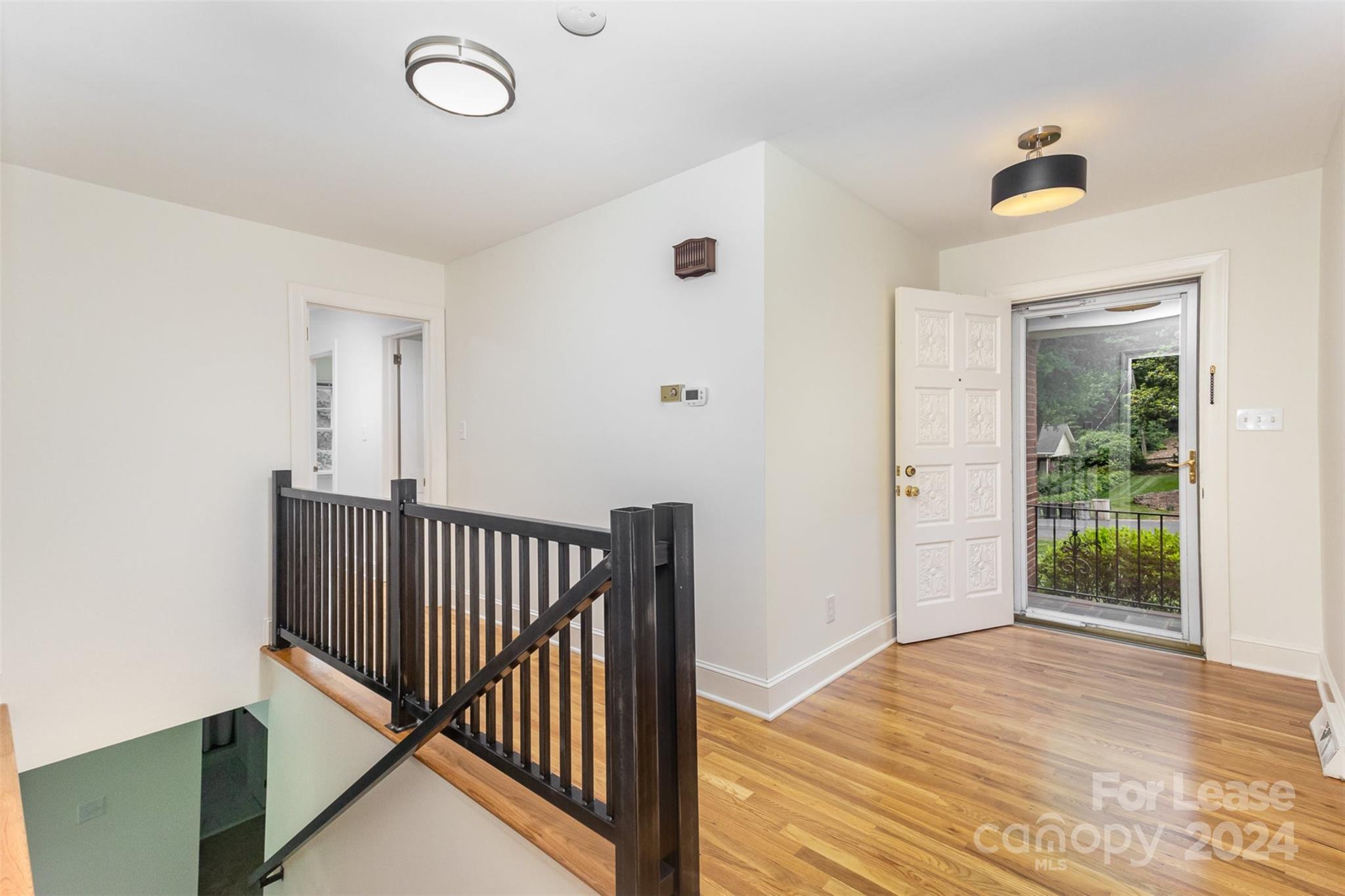 926 Shady Bluff Drive Charlotte, NC 28211 - Photo 8 of 44 a view of a hallway with wooden floor and entryway