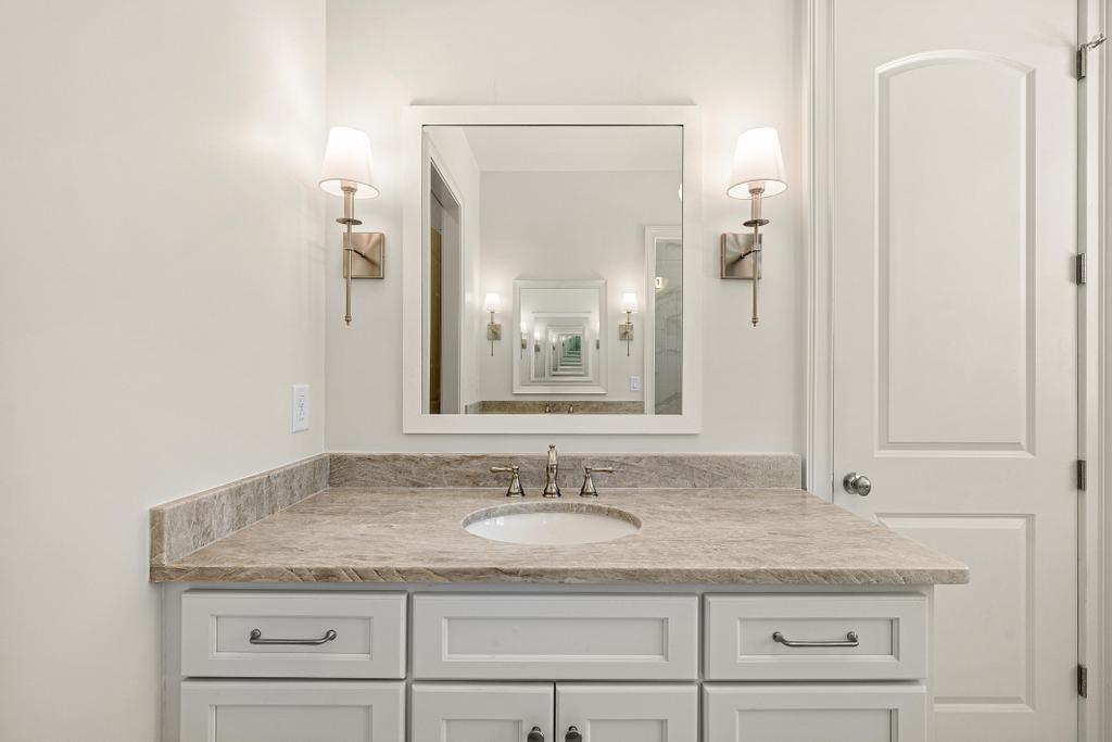 707 Vickery Street Extension Hartwell, GA 30643 - Photo 23 of 50 A well-appointed bathroom vanity features a broad counter with integrated sink and modern fixtures.