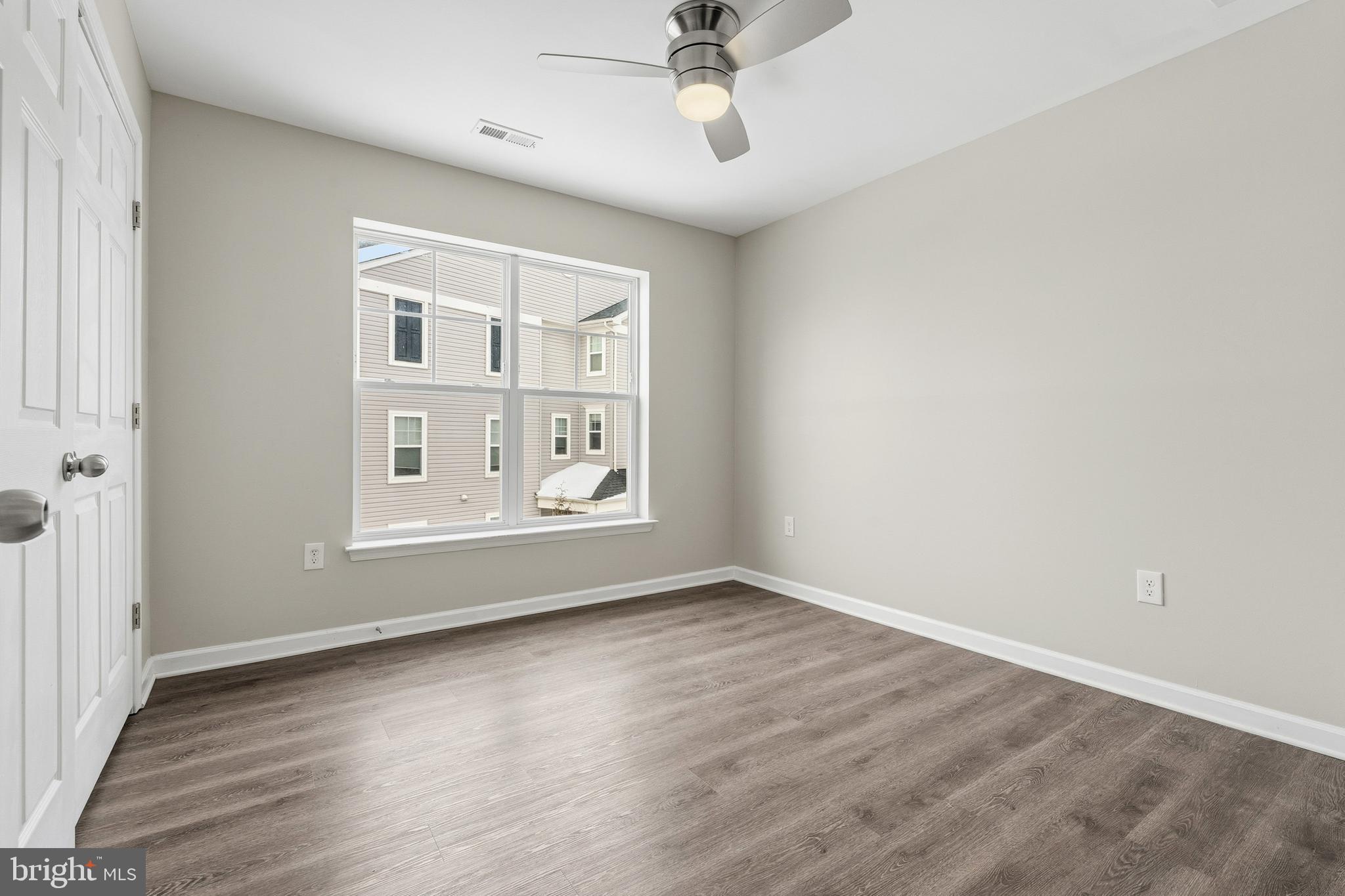 5902 Forum Square Frederick, MD 21703 - Photo 14 of 28 wooden floor in an empty room with a window