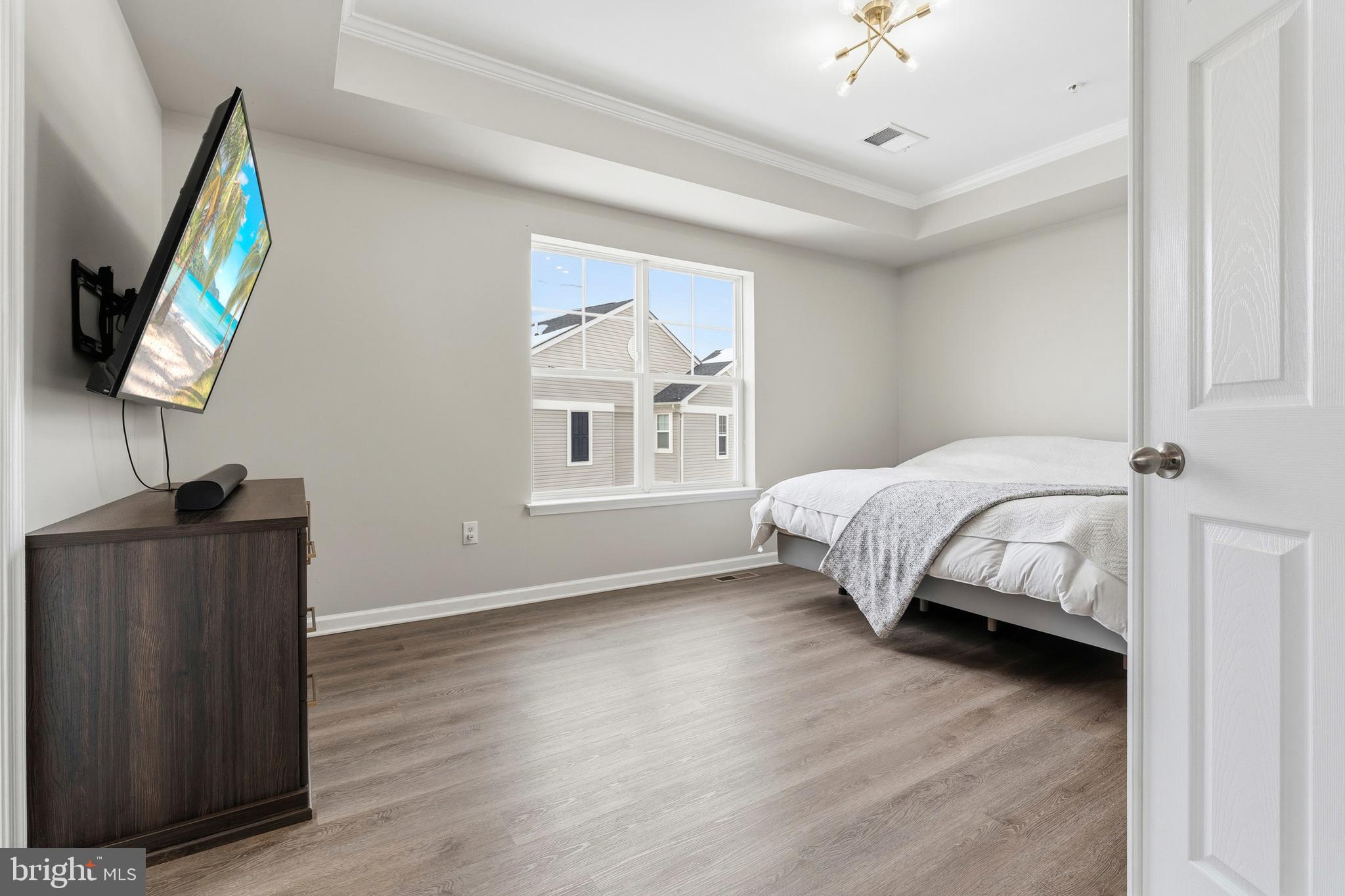 5902 Forum Square Frederick, MD 21703 - Photo 18 of 28 a bedroom with a bed wooden floor and window