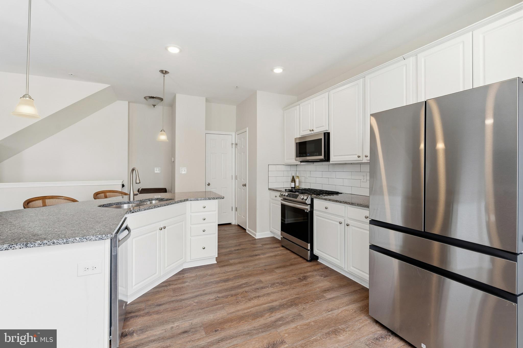 5902 Forum Square Frederick, MD 21703 - Photo 6 of 28 a kitchen with granite countertop a refrigerator stove and sink