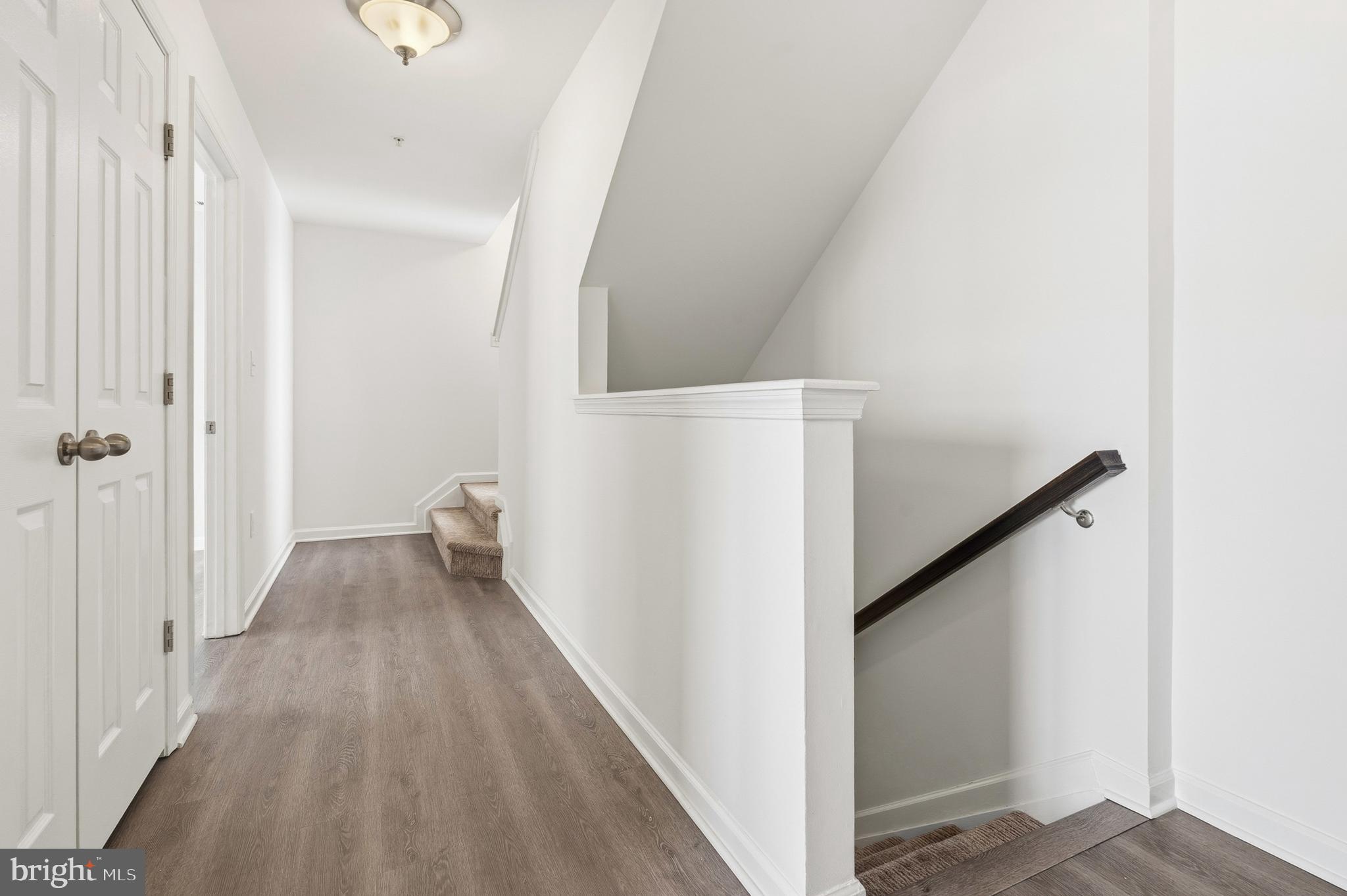 5902 Forum Square Frederick, MD 21703 - Photo 10 of 28 a view of a hallway with wooden floor and staircase
