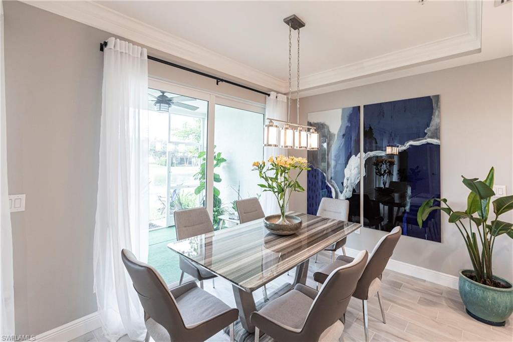 2319 Sawyers Hill Road, Unit 703 Naples, FL 34120 - Photo 11 of 35 a view of a dining room with furniture window and outside view