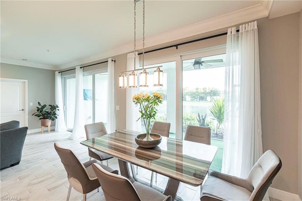 2319 Sawyers Hill Road, Unit 703 Naples, FL 34120 - Photo 14 of 35 a view of a dining room with furniture window and wooden floor