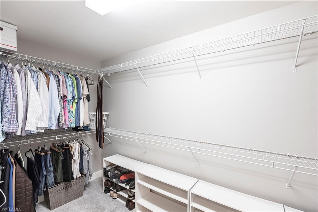2319 Sawyers Hill Road, Unit 703 Naples, FL 34120 - Photo 19 of 35 a view of walk in closet with clothes and shoes