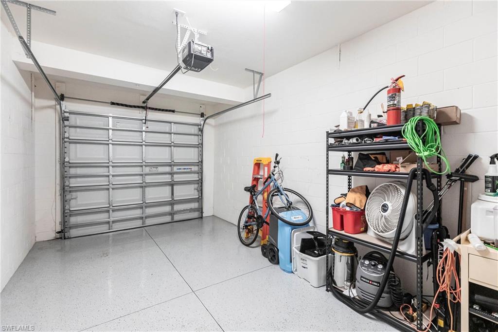 2319 Sawyers Hill Road, Unit 703 Naples, FL 34120 - Photo 28 of 35 a view of a garage with rack and bicycle
