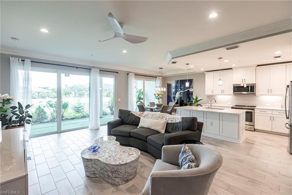 2319 Sawyers Hill Road, Unit 703 Naples, FL 34120 - Photo 5 of 35 a living room with furniture and a large window