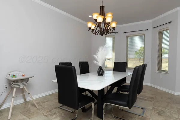 a view of a dining room with furniture wooden floor and chandelier