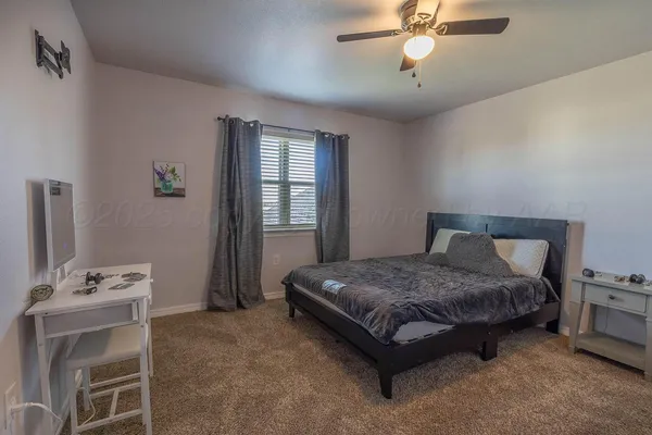 a spacious bedroom with a bed and a chandelier