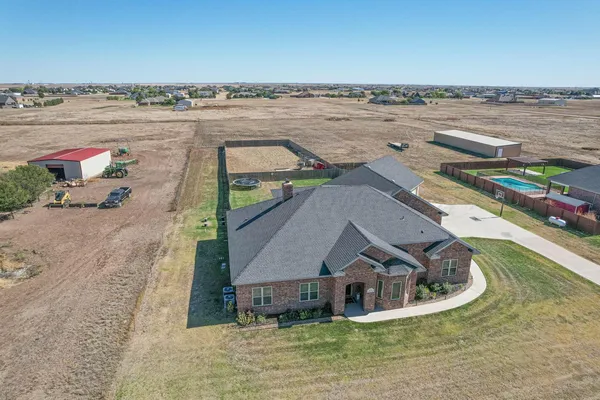 an aerial view of a house with a lake view