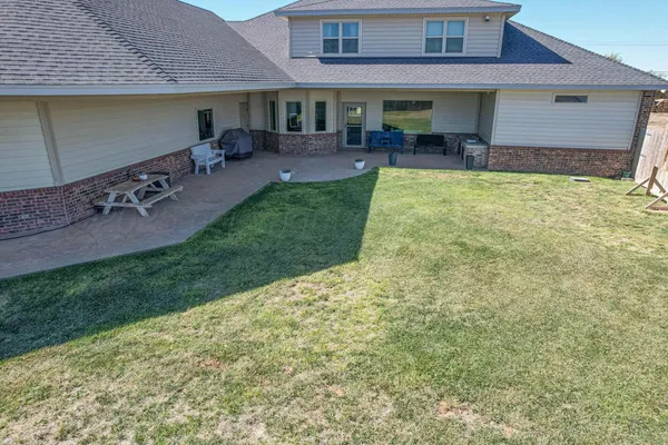 an aerial view of a house with a yard and lake view
