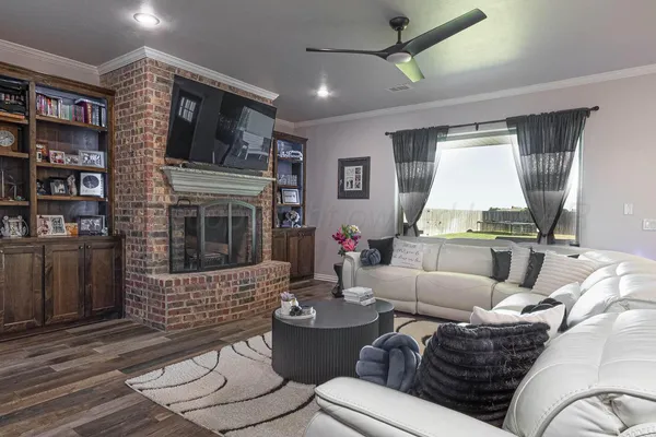a living room with furniture a fireplace and a flat screen tv