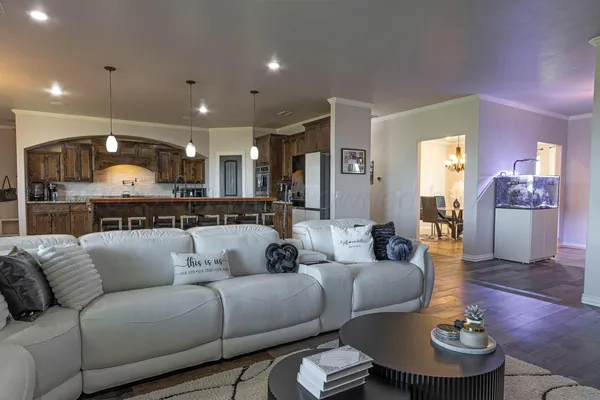 a living room with furniture and kitchen view