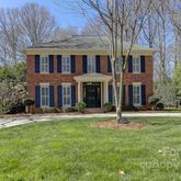 a house with lots of trees in the background