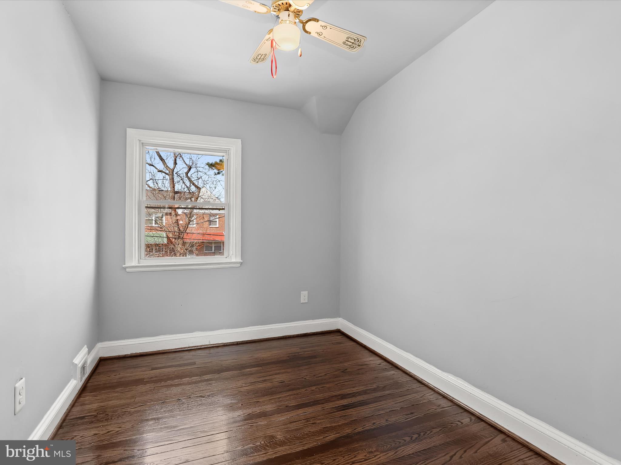 1350 Pentwood Road Baltimore, MD 21239 - Photo 26 of 37 wooden floor in an empty room with a window