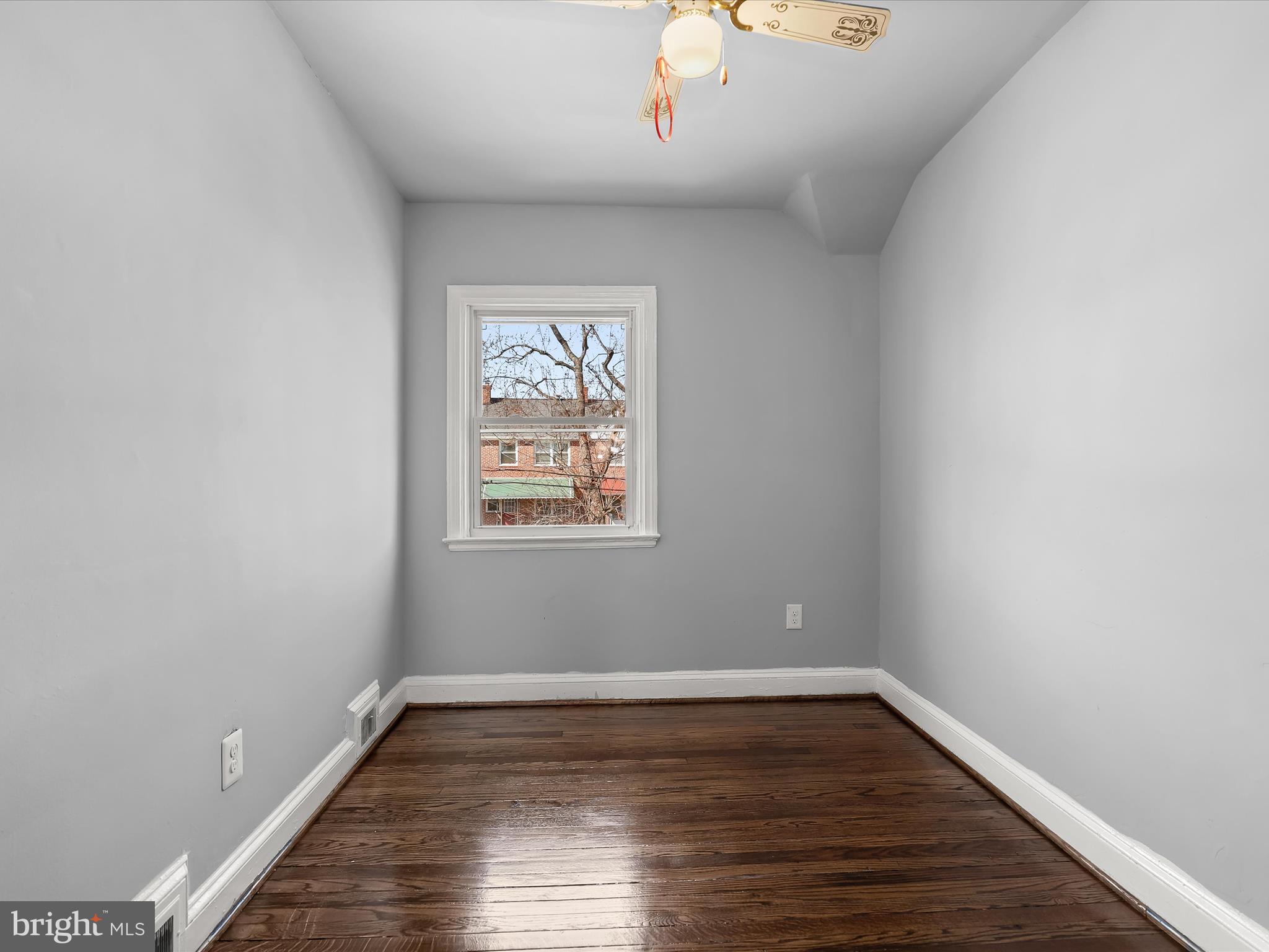 1350 Pentwood Road Baltimore, MD 21239 - Photo 27 of 37 a view of an empty room with wooden floor and a window
