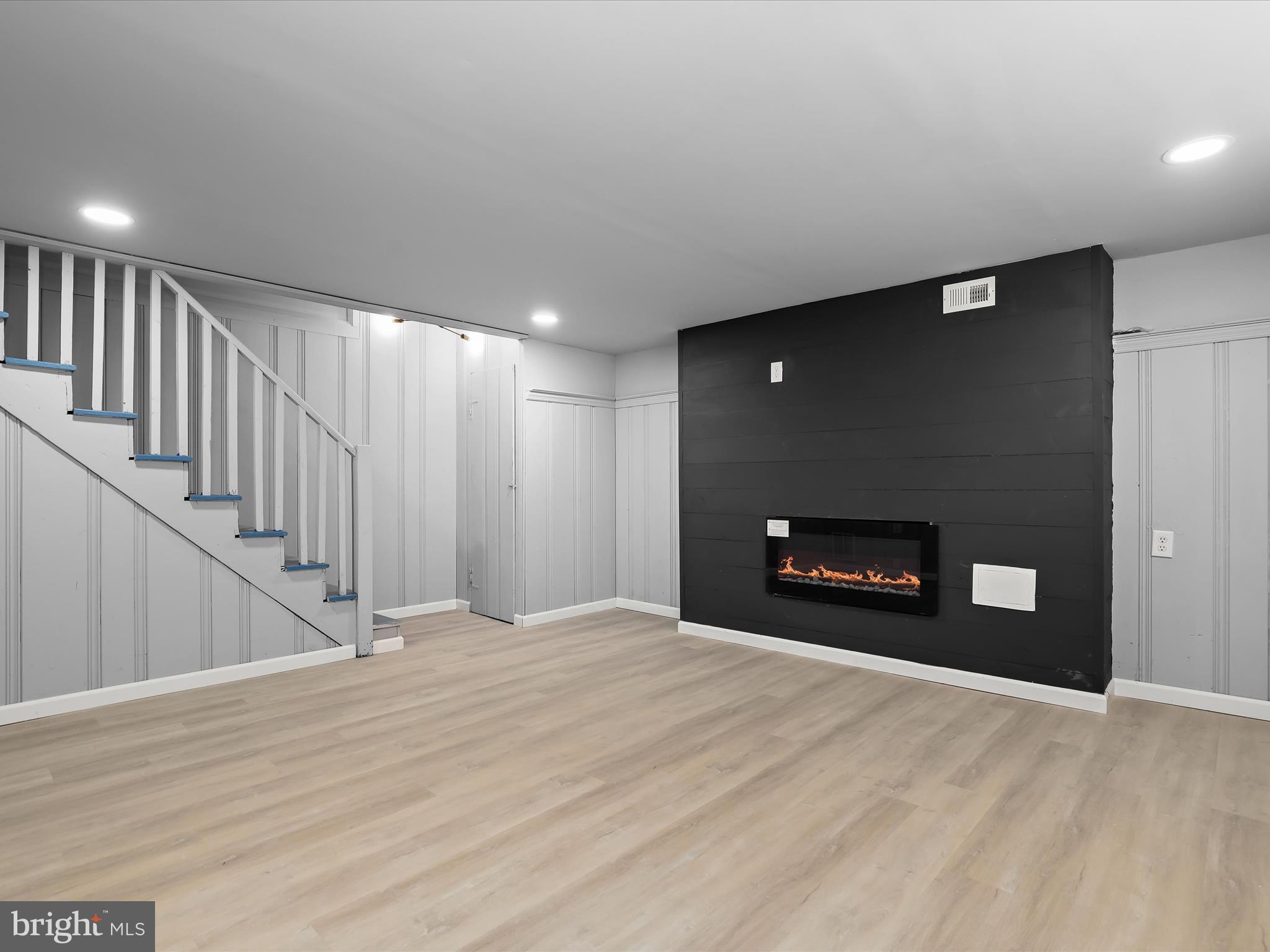 1350 Pentwood Road Baltimore, MD 21239 - Photo 29 of 37 a view of an empty room with wooden floor and a fireplace