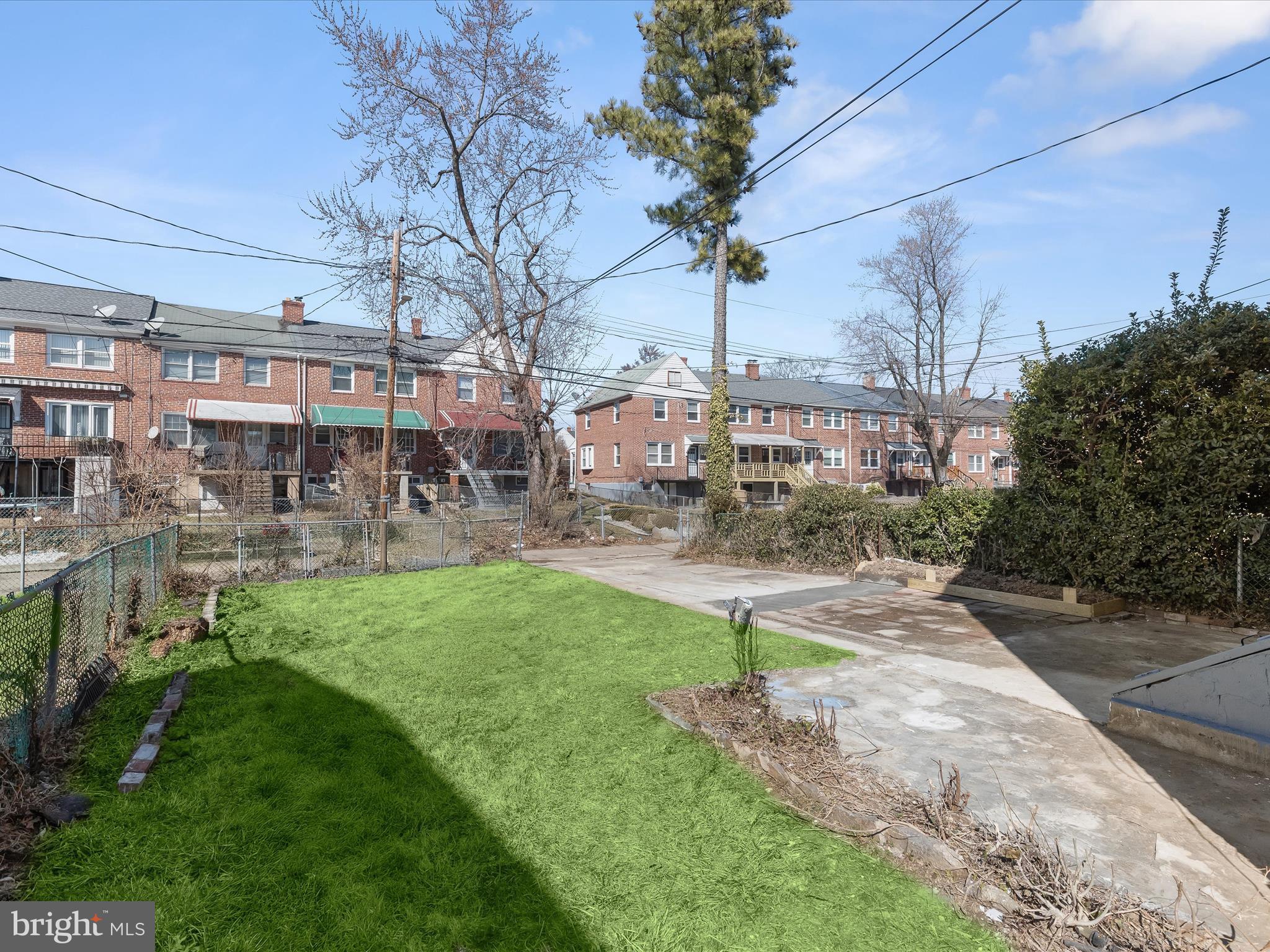 1350 Pentwood Road Baltimore, MD 21239 - Photo 32 of 37 a front view of a building with a garden and trees