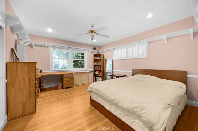 a spacious bedroom with a large bed and a dresser