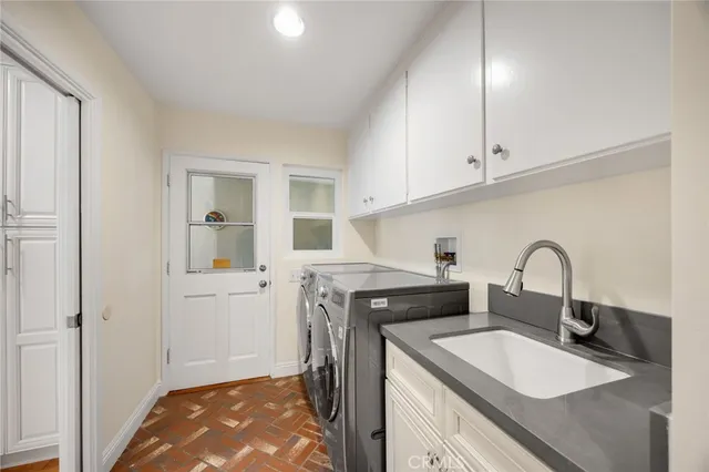 a kitchen with a sink cabinets and appliances
