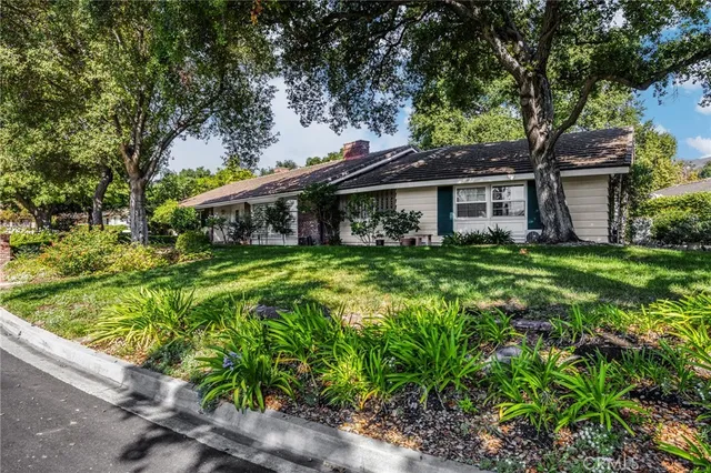 a view of a house with pool and garden