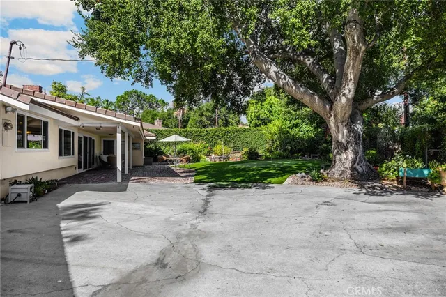 a view of a house with a tree in the background