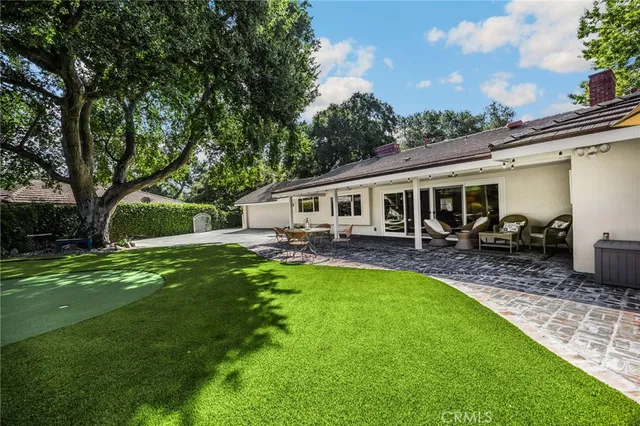 a view of a house with a backyard porch and sitting area
