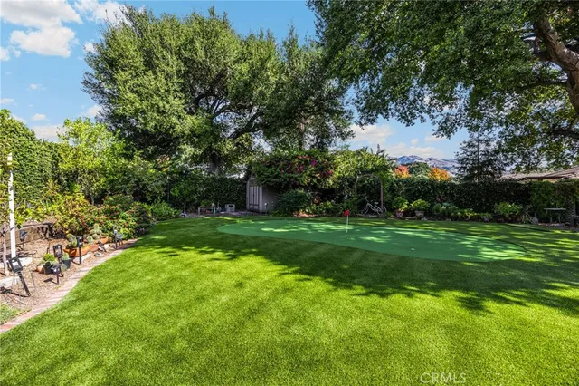 a view of a field of grass and trees