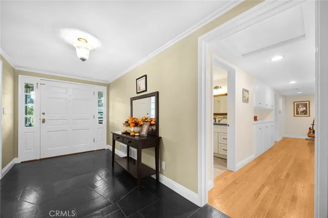 a view of a bedroom with wooden floor