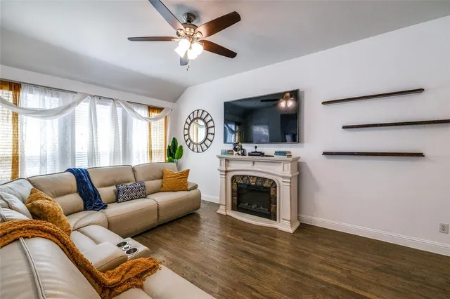 a living room with furniture a fireplace and a flat screen tv