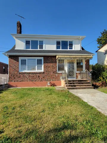 a front view of a house with yard