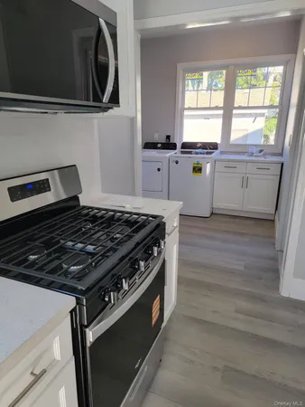 a kitchen with granite countertop a stove and a sink