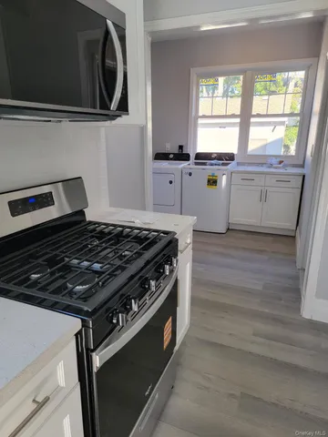 a kitchen with granite countertop a stove and a sink