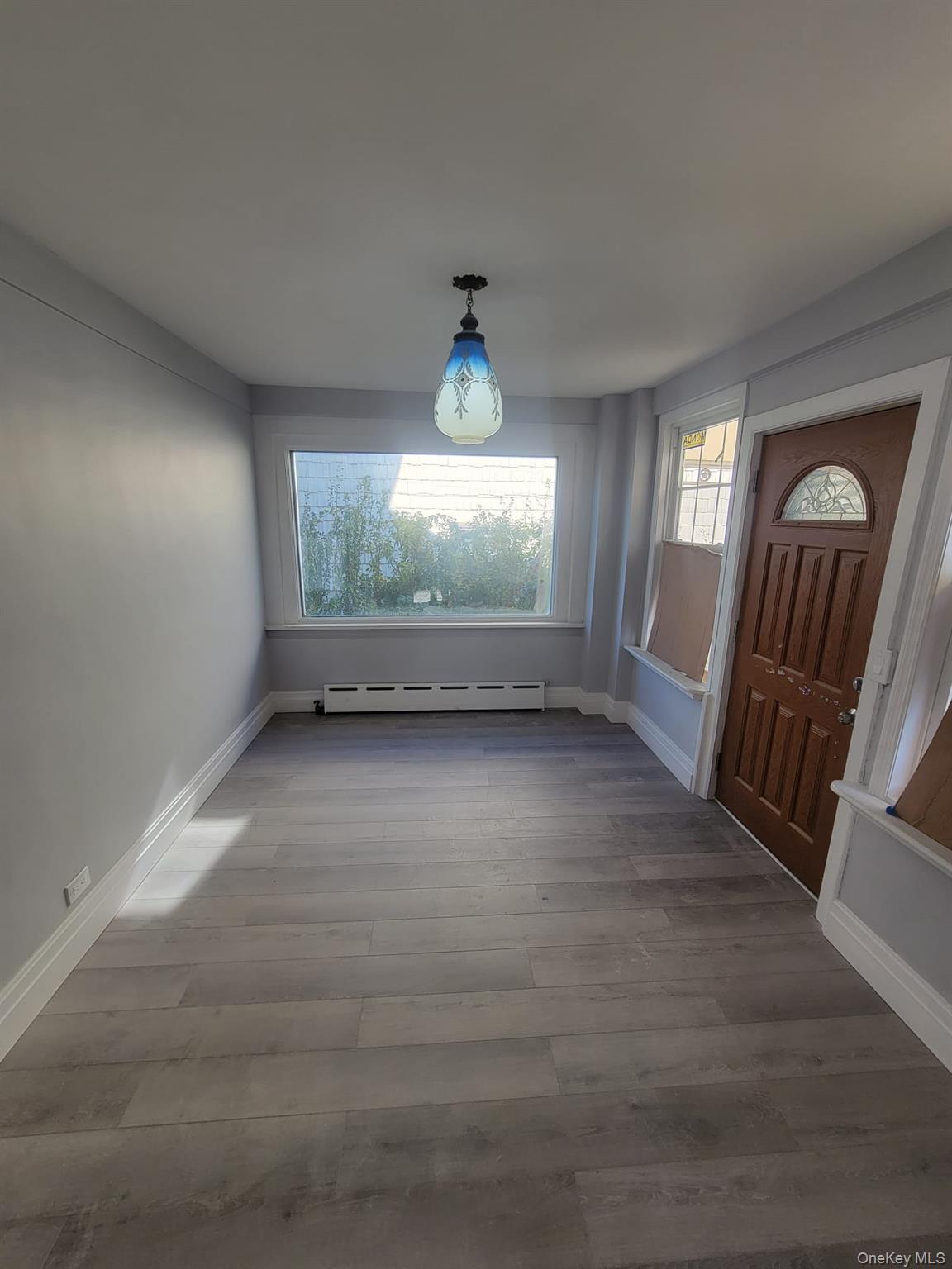 315 Mill Road Hewlett, NY 11557 - Photo 7 of 12 wooden floor in an empty room with a window