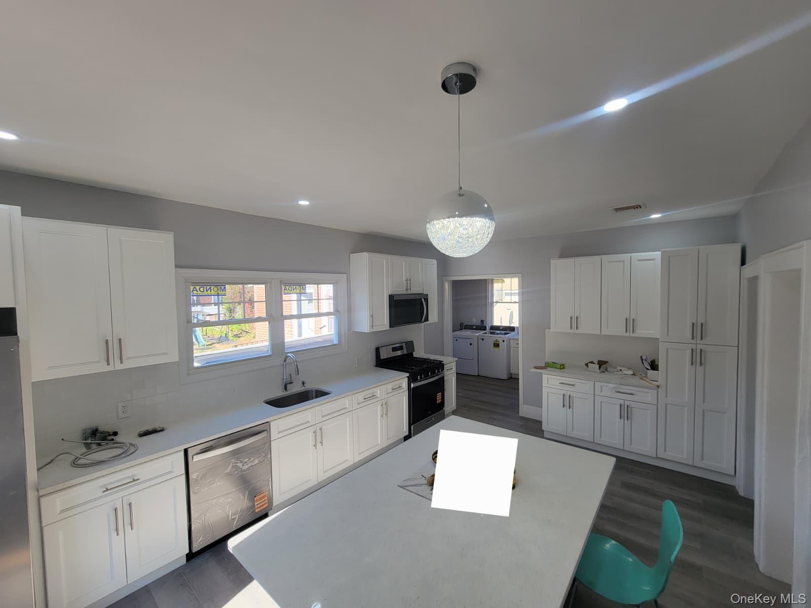 315 Mill Road Hewlett, NY 11557 - Photo 9 of 12 a kitchen with refrigerator and cabinets