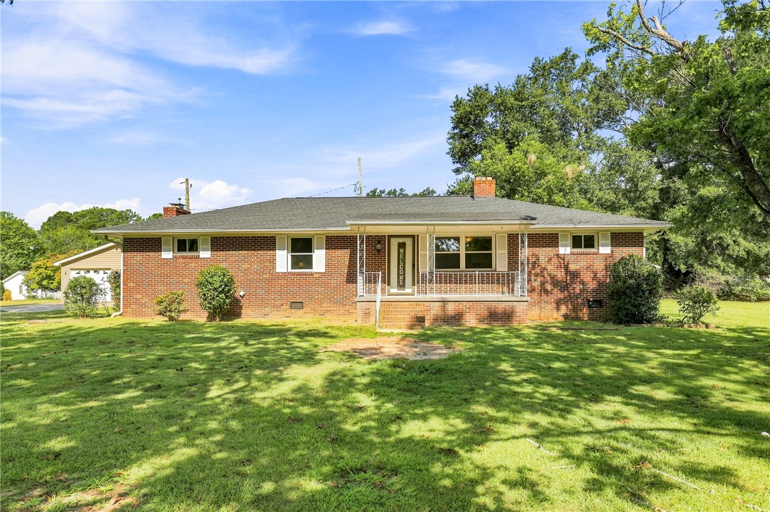 205 Timms Road Piedmont, SC 29673 - Photo 1 of 36 Mature trees shade the brick exterior and front porch of this classic ranch-style home.