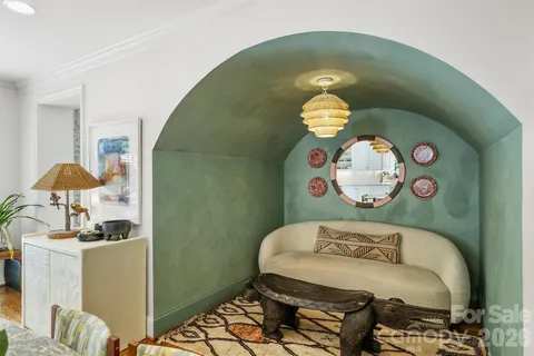 a bedroom with a bed and chandelier