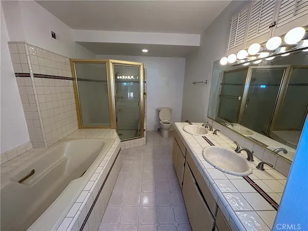 a bathroom with a tub sink and mirror