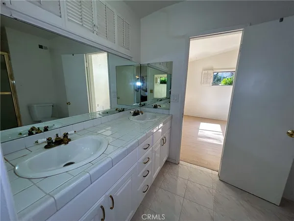 a bathroom with a double vanity sink and a mirror