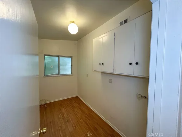 a view of a room with wooden floor and fan