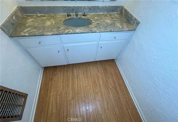 a view of kitchen countertops with wooden floor
