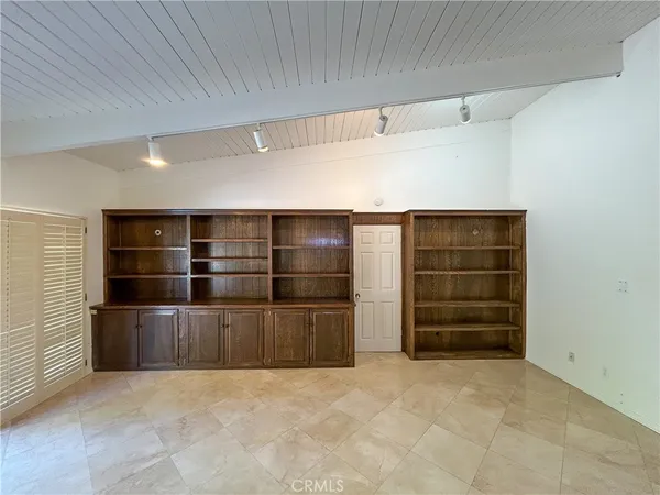 a view of an empty room and a window