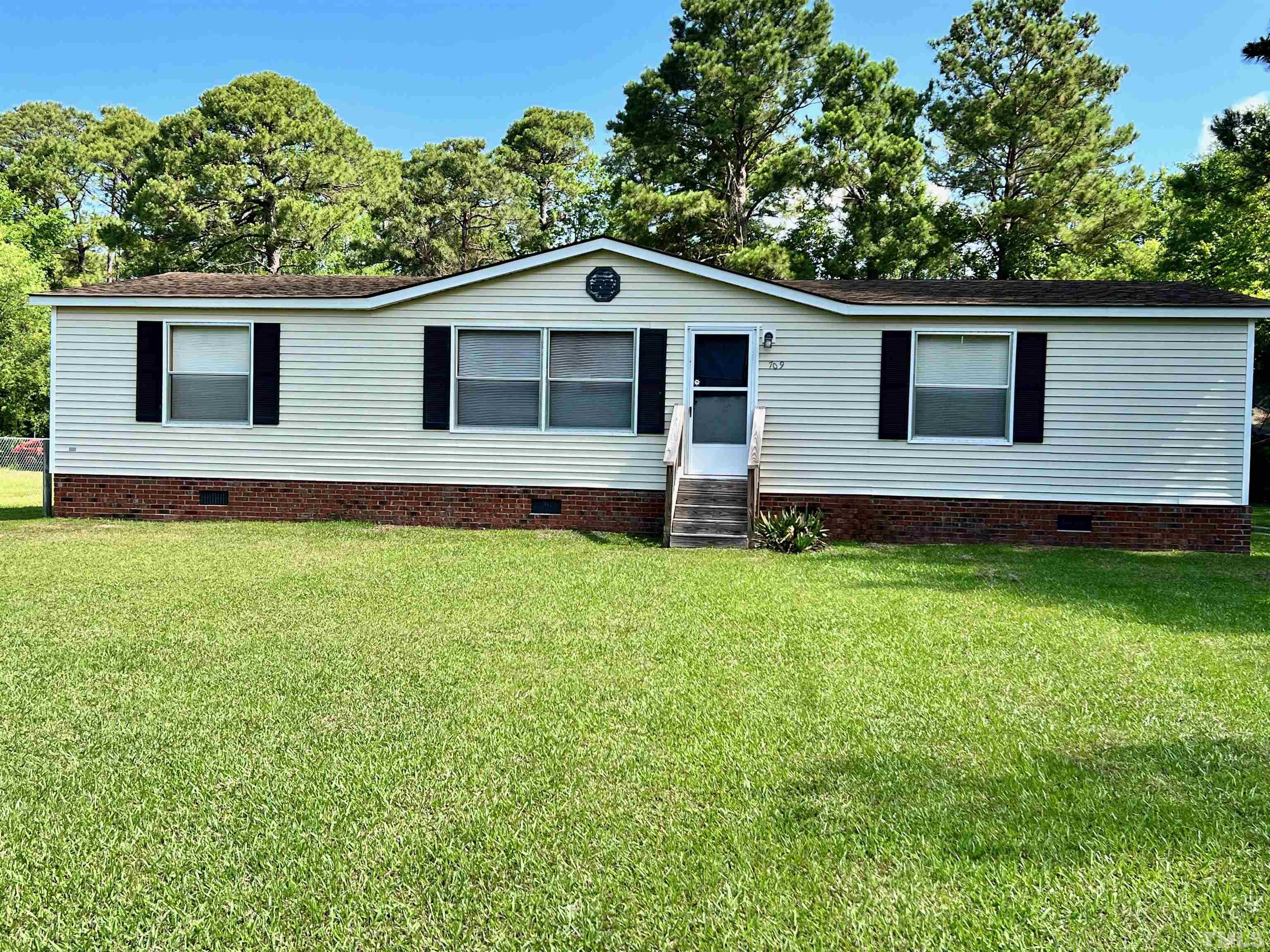 709 Carolina Inlet Acres Road Wilmington, NC 28412 - Photo 1 of 26 a front view of a house with a yard