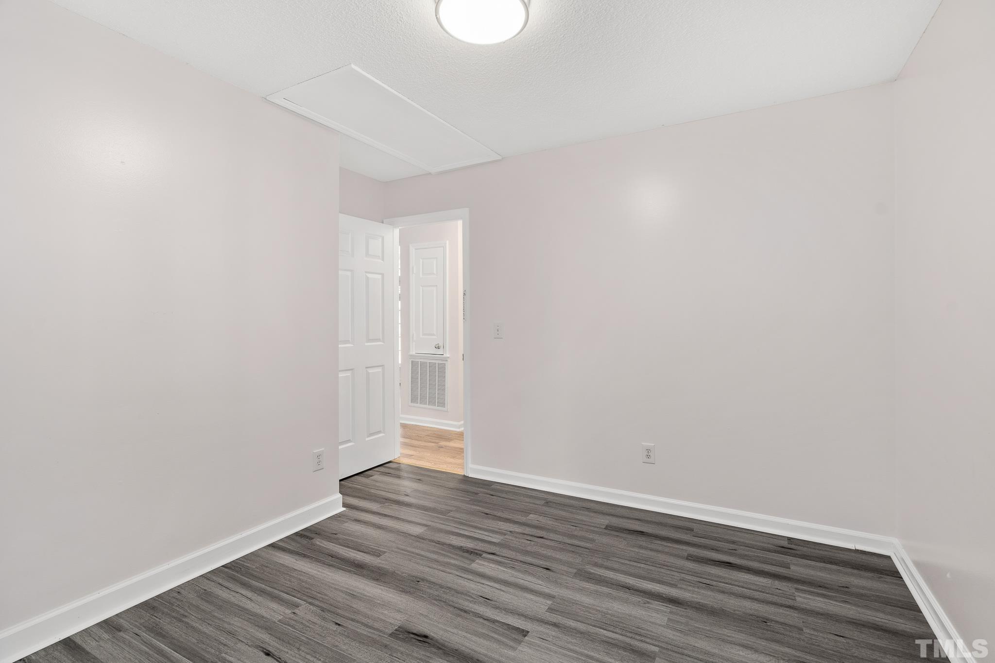 2201 Quail View Trail Raleigh, NC 27604 - Photo 15 of 28 a view of an empty room with wooden floor