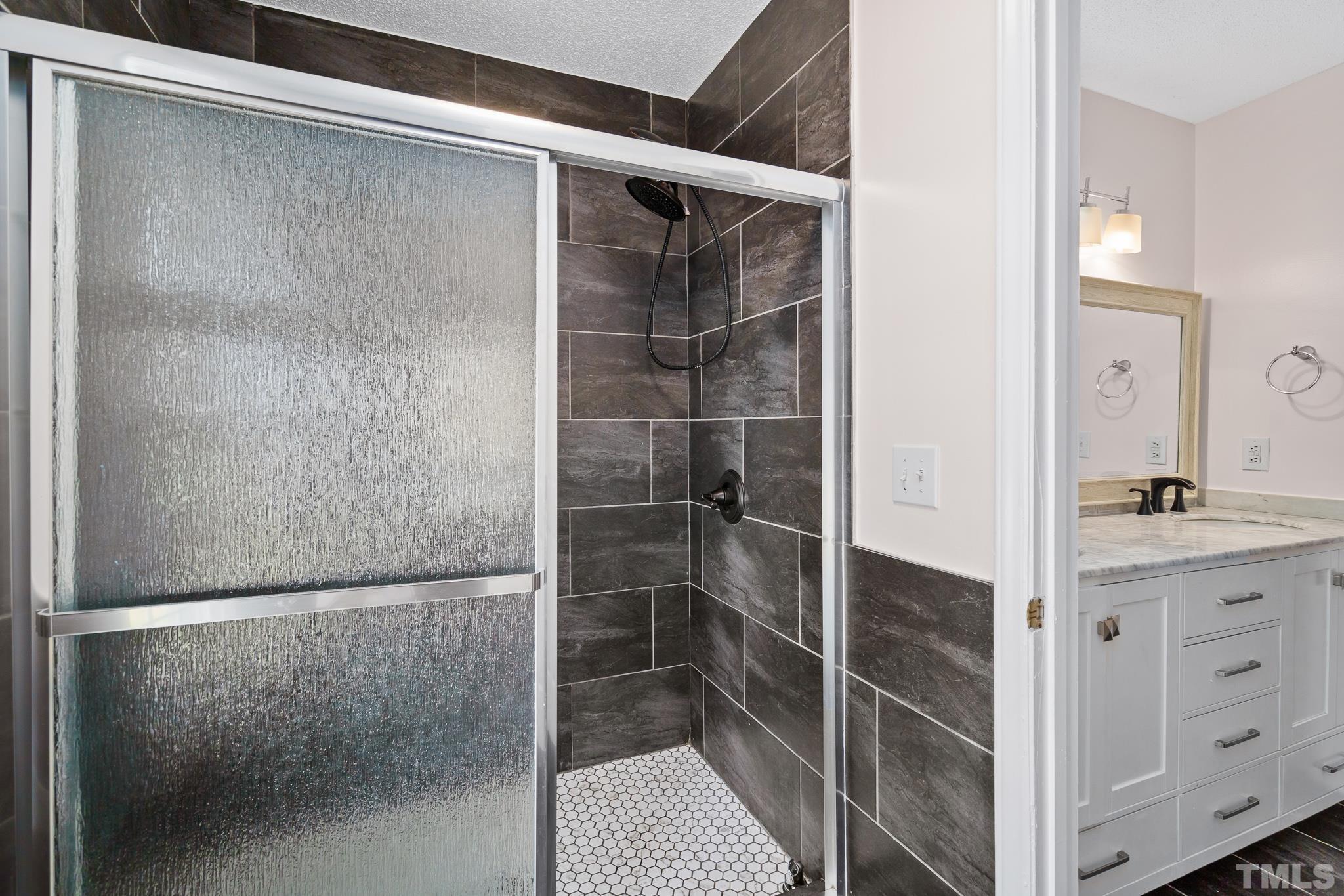 2201 Quail View Trail Raleigh, NC 27604 - Photo 24 of 28 a bathroom with a shower and a sink