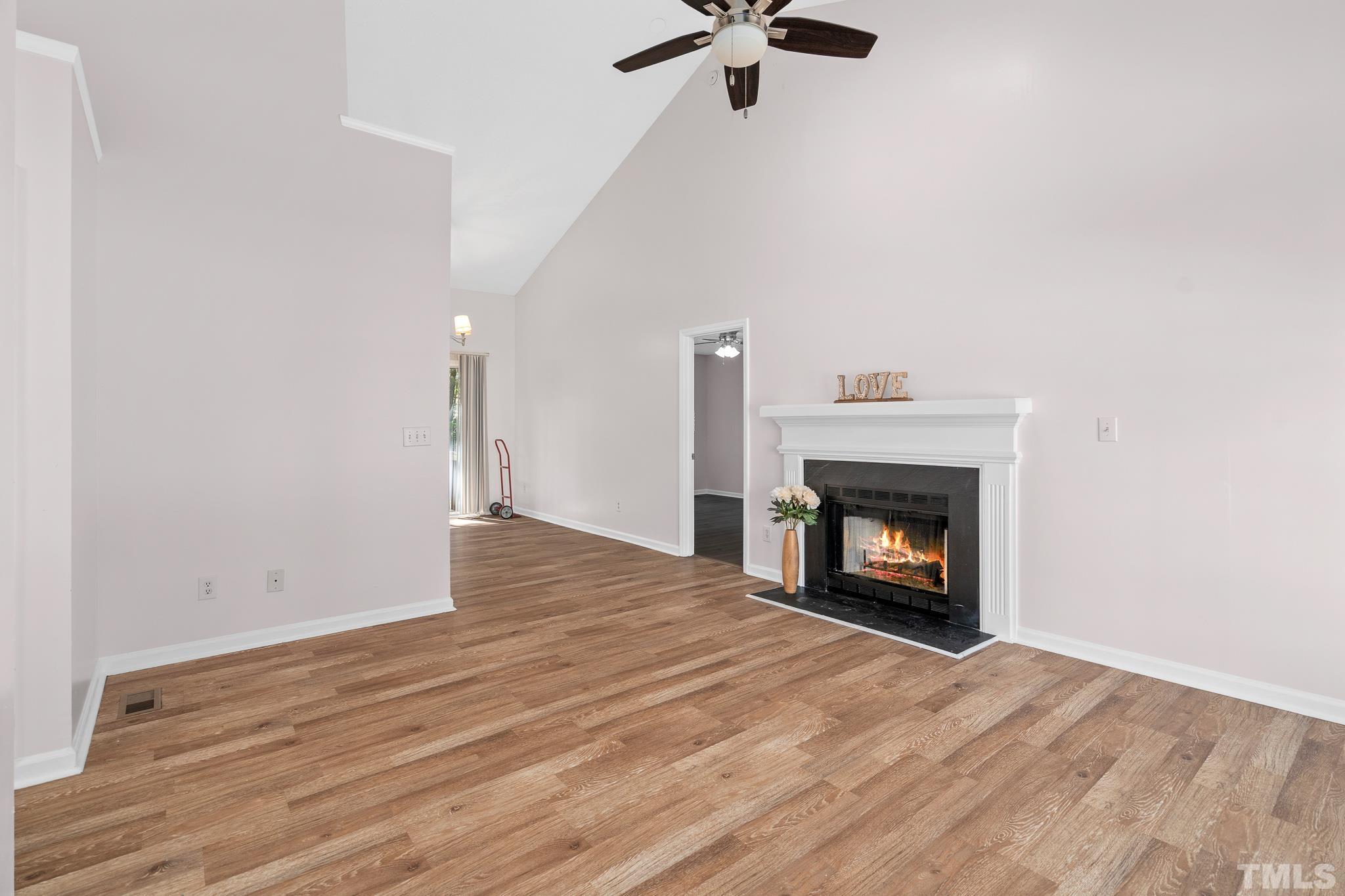 2201 Quail View Trail Raleigh, NC 27604 - Photo 3 of 28 a view of an empty room with wooden floor fireplace and a window