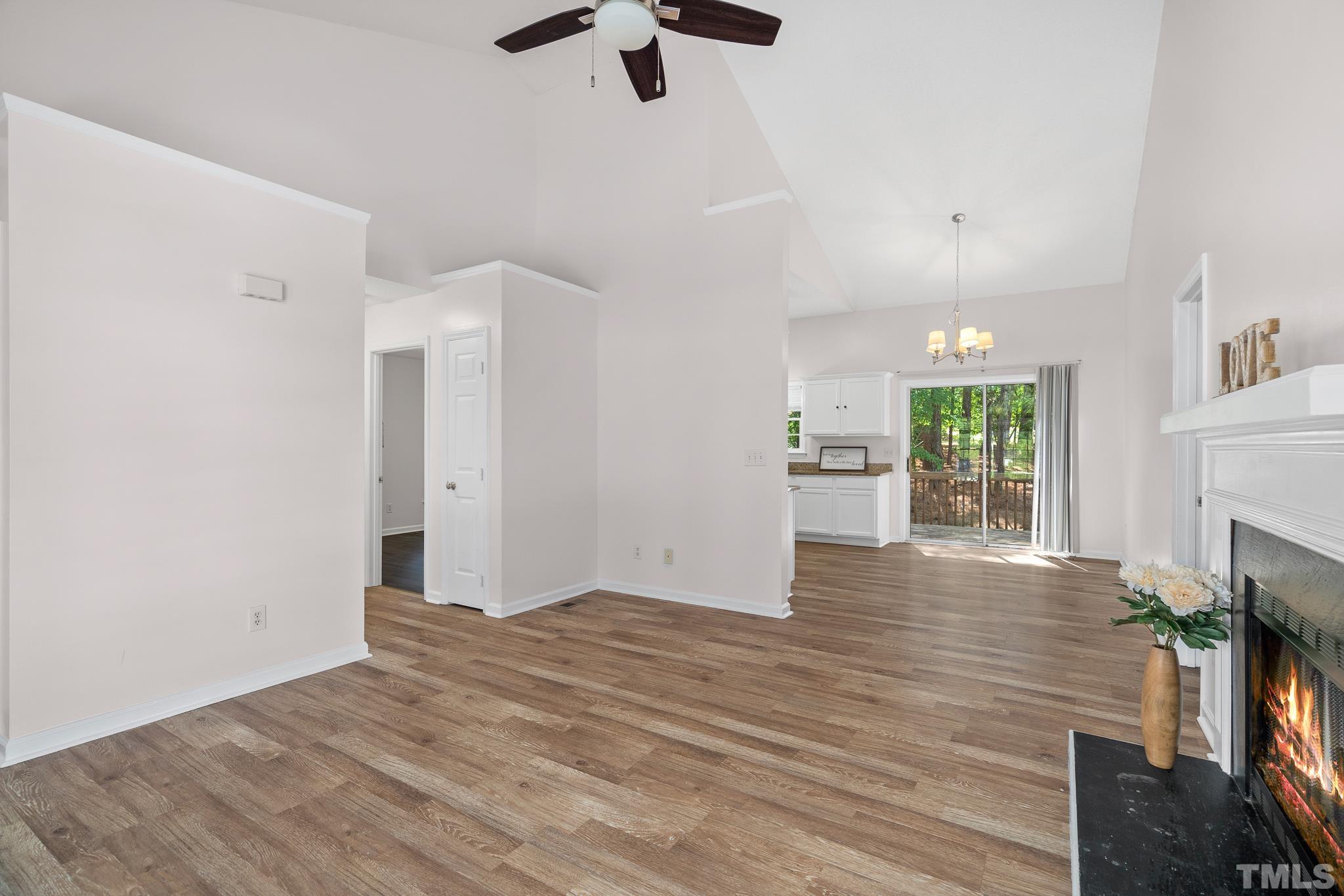2201 Quail View Trail Raleigh, NC 27604 - Photo 6 of 28 wooden floor in an empty room with a fireplace