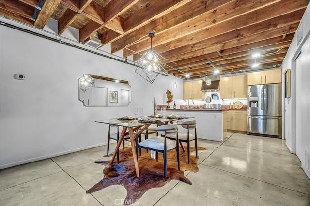 a kitchen with stainless steel appliances granite countertop a refrigerator a stove and a sink